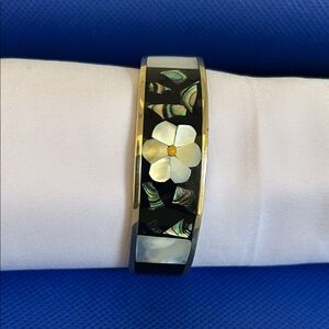 Silver cuff bracelet with inlaid floral design